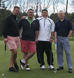 From left, Brian Cuddeback, Todd Hellyar, Jeff Lin and Neil Dryfe take a break during the Migli benefit golf tournament.