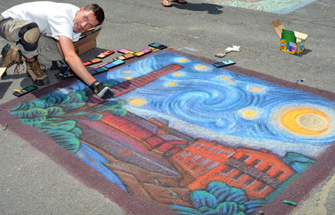 Burlington's Chris O'Herron puts the finishing touches on his entry at the Chalk Walk on River Street.