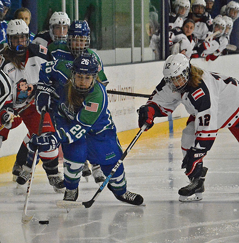 Connecticut's Jordan Brickner (26) tries to move up ice away from New York's Janine Weber (12)