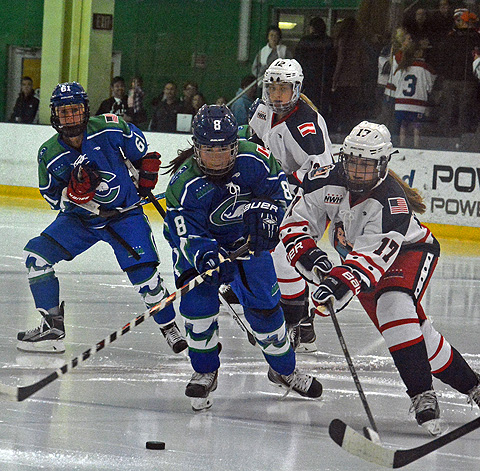 Connecticut's Kelly Babstock (8) and New York's Bray Ketchum (17) from Greenwich battle for the puck in the first-ever NWHL game in Stamford Sunday.