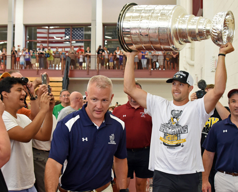 Farmington native Nick Bonino carries in the Stanley Cup to Thursday's event at Avon Old Farms. 