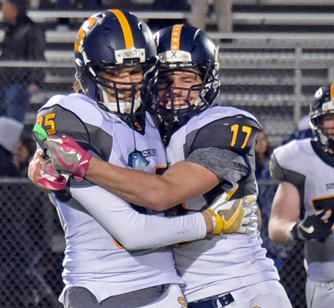 Simsbury's Danny Deitz, left, and Sean Penney celebrate after Simsbury's 52-21 win over Enfield on Friday night.