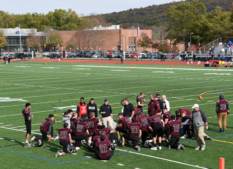 The Warriors regroup at halftime of a recent game at the high school.
