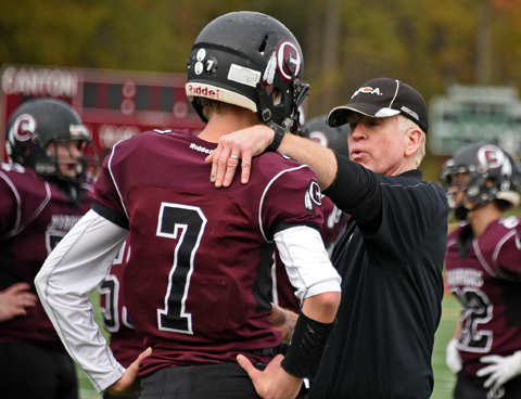 Former Canton High head coach Mike Guy provides some guidance to QB XXXXX. 